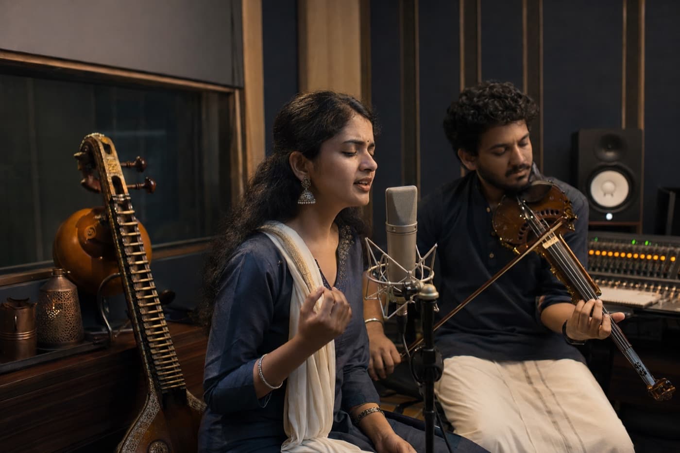 Tamil musicians recording vocals and violin in a studio